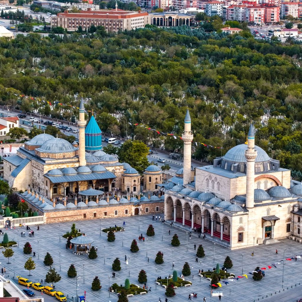 Vibrant aerial view of the iconic Mevlana Museum located in Konya, Türkiye, surrounded by lush greenery. — 6 Reasons Women ar