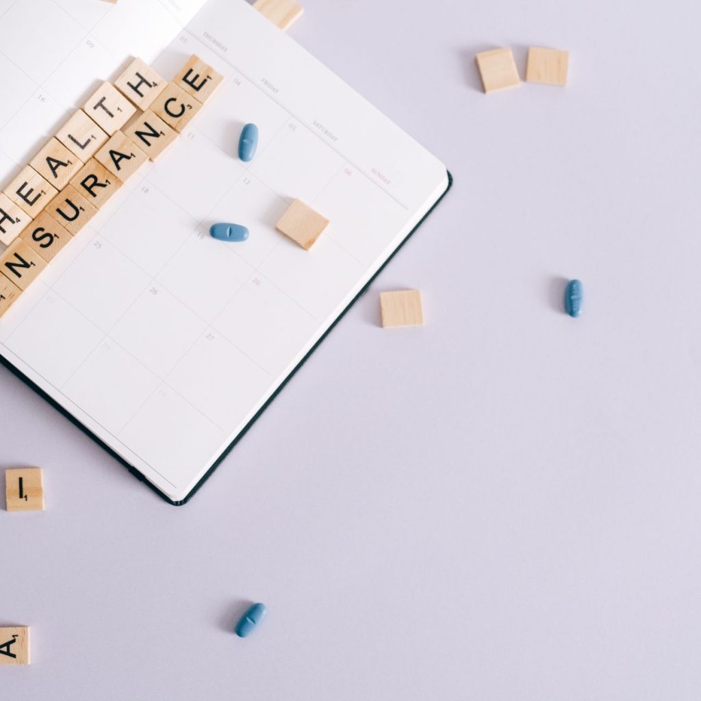 Flat lay of health insurance concept with planner and pills. — 6 Things For Successful Diabetes Management In A Hectic Life