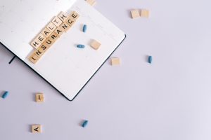 Flat lay of health insurance concept with planner and pills. — 6 Things For Successful Diabetes Management In A Hectic Life