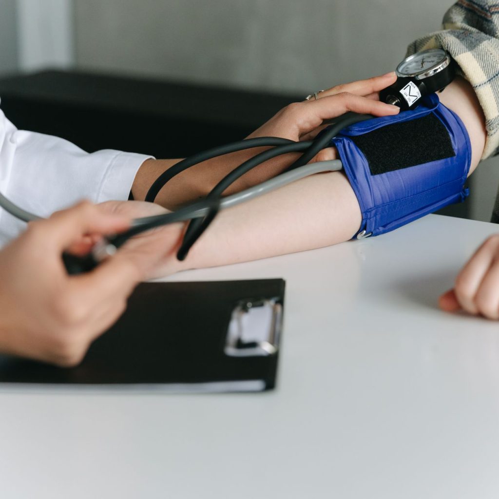 A healthcare worker uses a sphygmomanometer to check a patient's blood pressure in a medical office. — A Detailed Look of CBD
