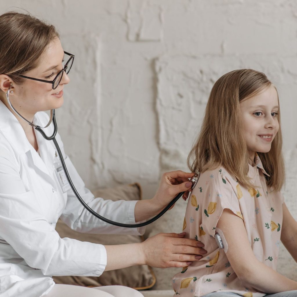 A doctor uses a stethoscope during a check-up with a young girl in a medical setting. — A Must-Know When Dealing With Hazardo