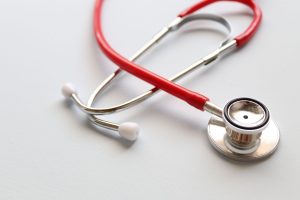Close-up of a red stethoscope symbolizing medical care and healthcare diagnostics. — About The Different Types Of Anthem Insu