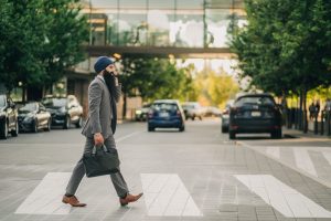 Sikh businessman with a turban crossing a city street on a zebra crossing, carrying a briefcase. — All-Round Contribution: Ge
