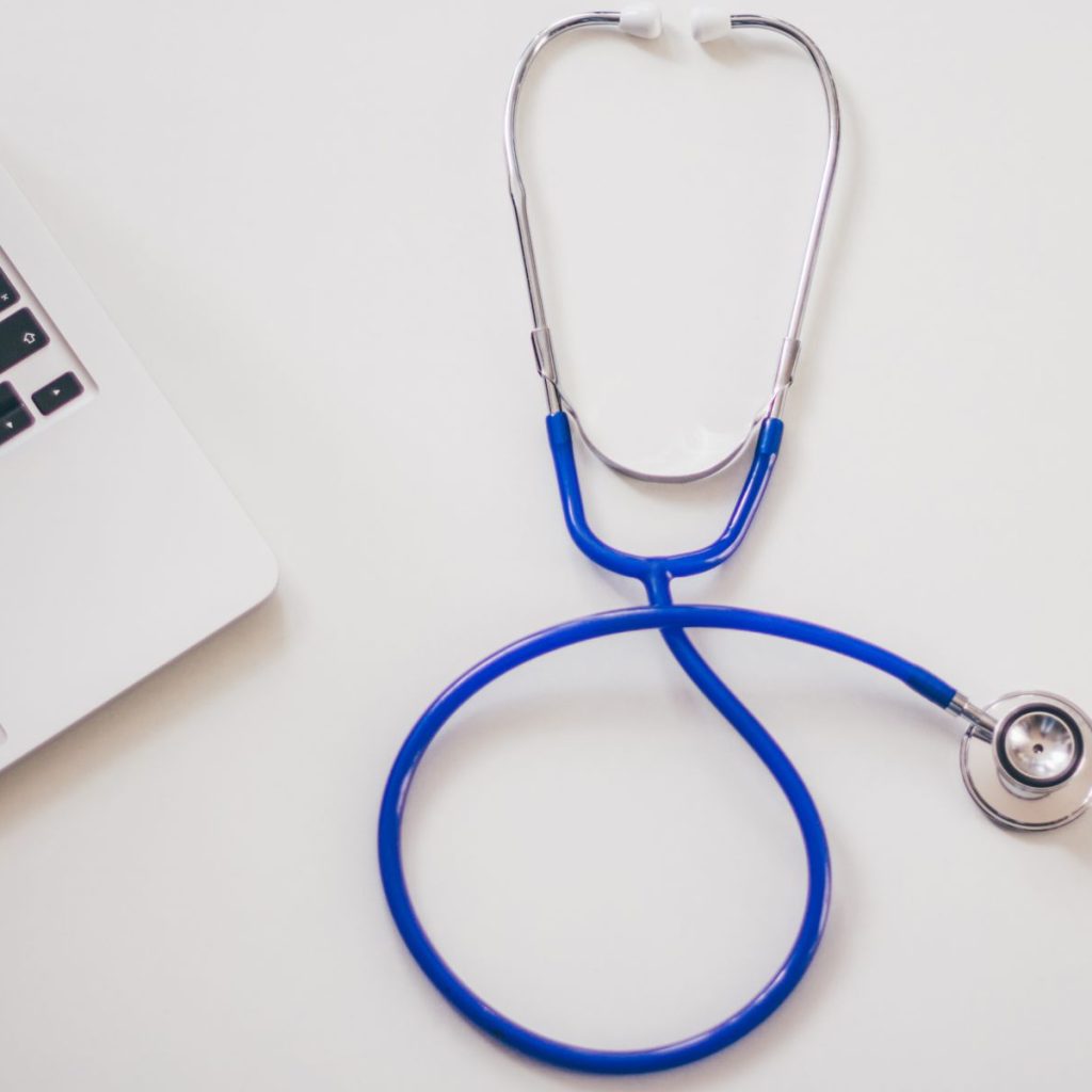 Medical stethoscope and laptop on a white desk, symbolizing digital health solutions. — An Informative Guide about Kratom and
