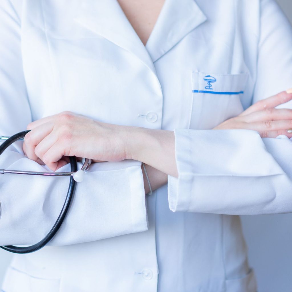A close-up image of a doctor in a white coat with a stethoscope and arms crossed. — Different types of vape juice that you ca