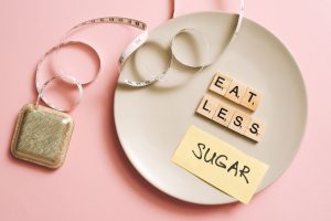 A conceptual image featuring a plate with messages made from Scrabble tiles and a tape measure, promoting healthy eating. — E