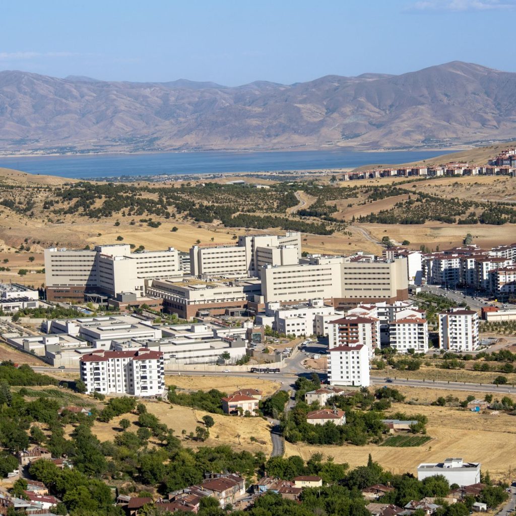 Stunning aerial photograph capturing the expansive cityscape of Elâzığ, Türkiye, with distant mountains. — Essential Features