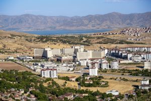Stunning aerial photograph capturing the expansive cityscape of Elâzığ, Türkiye, with distant mountains. — Essential Features