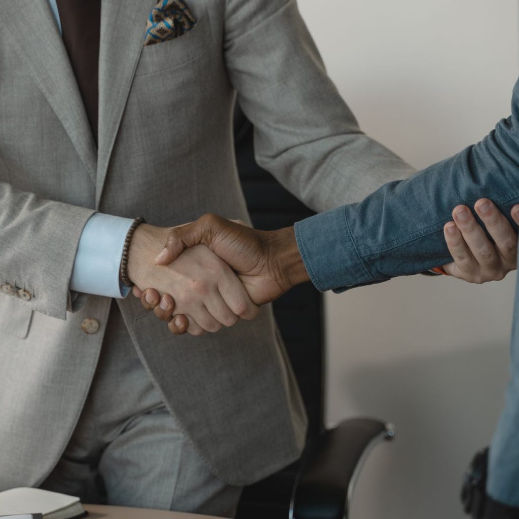 Image of a professional handshake between two businessmen in an office setting. — Feel Safe And Secure In ivy-glen Conway SC