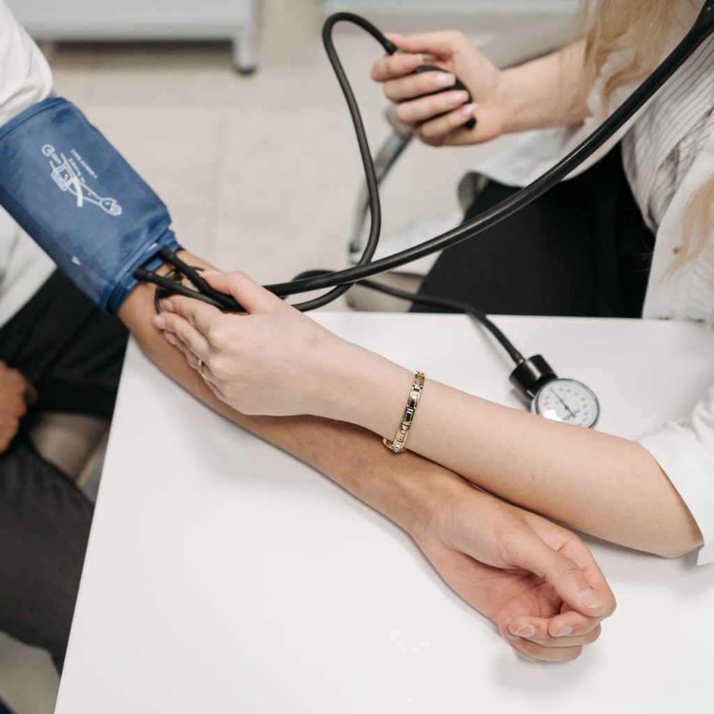 A doctor measures a patient's blood pressure with a sphygmomanometer during a consultation. — Finding Out Whether Slimroast C