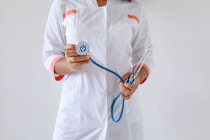 Close-up of a female doctor holding a blue stethoscope, emphasizing healthcare and professionalism. — Getting in Shape Will H