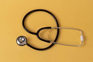 Close-up of a black stethoscope on a vibrant yellow surface, ideal for medical themes. — Health Literacy Statistics and Facts