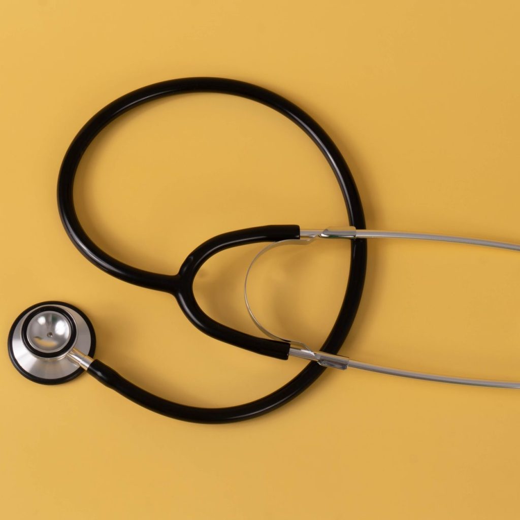 Close-up of a black stethoscope on a vibrant yellow surface, ideal for medical themes. — Marijuana legale in Italia