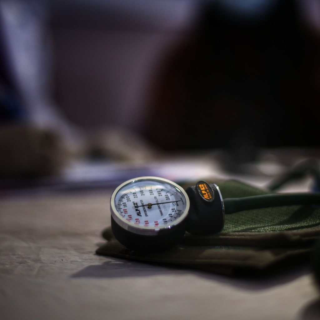 Detailed image of a medical sphygmomanometer on a table, indicating health check-up setting. — Pain Relieve Foods: Must Add T