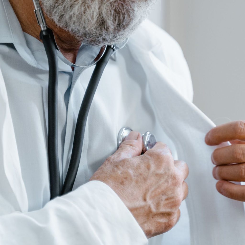 Close-up of a doctor adjusting a stethoscope while in a medical consultation. — Signs of an Addictive Personality