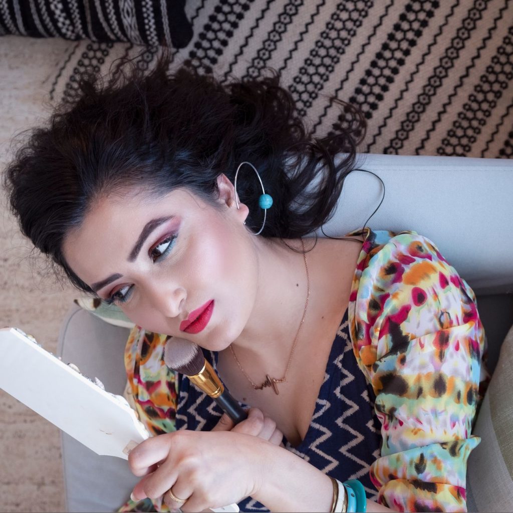 Portrait of a woman in vibrant attire looking in mirror, capturing elegance and style. — Some Great Hair Growth Aids For Heal
