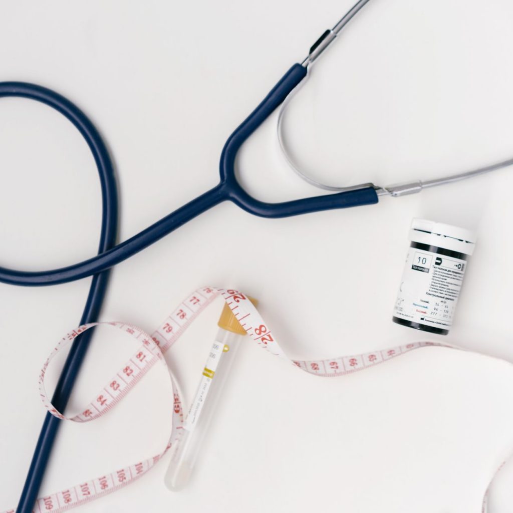 Flat lay of medical tools including stethoscope and measuring tape on a white background. — Take benefits of Medicare Supplem