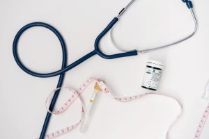 Flat lay of medical tools including stethoscope and measuring tape on a white background. — Take benefits of Medicare Supplem