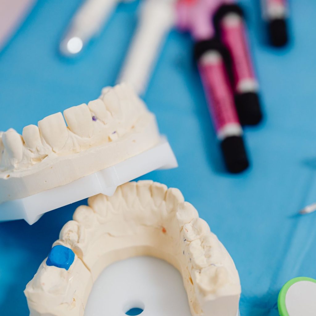 Dental jaw model with dental tools on a blue cloth for dental education and practice. — Too Young, Too Old: How Old Should Yo