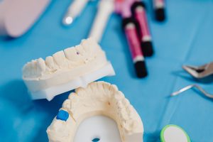 Dental jaw model with dental tools on a blue cloth for dental education and practice. — Too Young, Too Old: How Old Should Yo