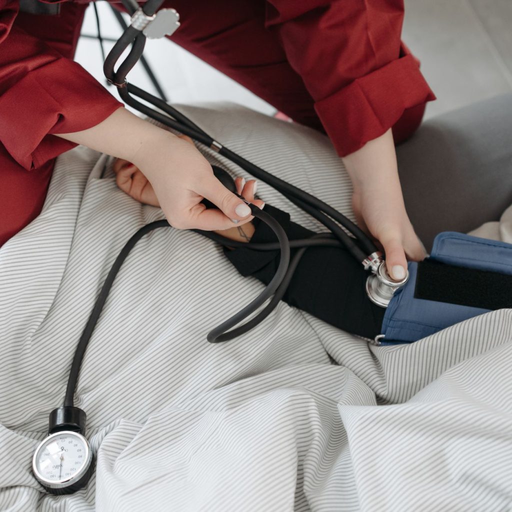 A medical professional checking a patient's blood pressure using a sphygmomanometer in a cozy setting. — Top 4 Cartoon Charac
