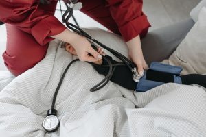 A medical professional checking a patient's blood pressure using a sphygmomanometer in a cozy setting. — Top 4 Cartoon Charac