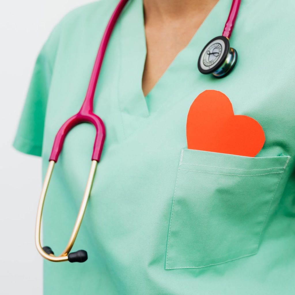 A healthcare professional with a stethoscope and red heart symbol emphasizes cardiology care. — Try an Online Yoga Class Toda