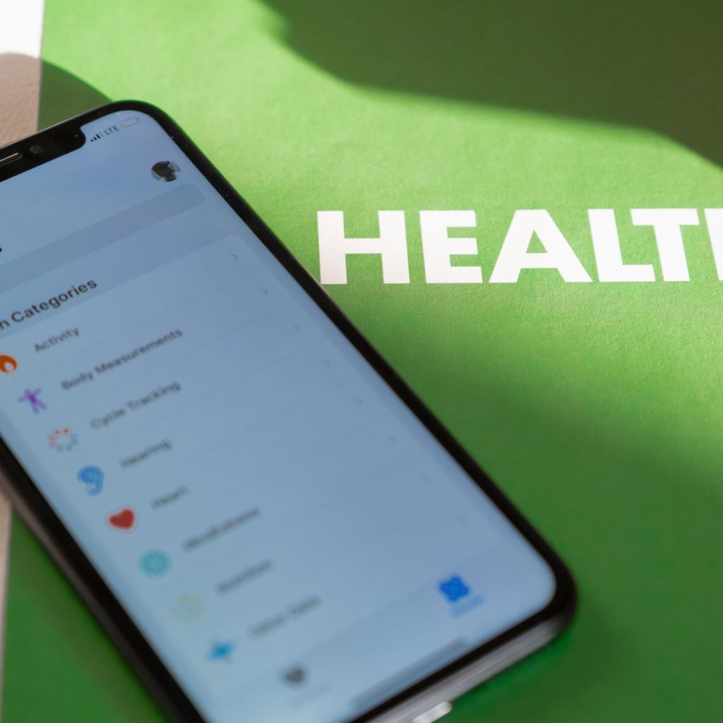 Close-up of a smartphone displaying a health app on a green surface with 'HEALTH' text. — Ultimate guide to ultherapy - What
