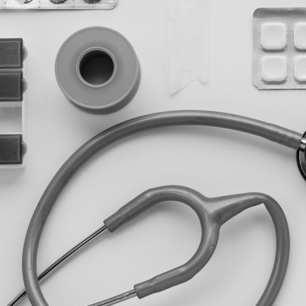 Top view of medical instruments and pills arranged on a white background. — Understanding CBD oil for Anxiety
