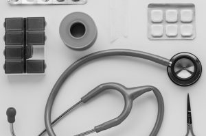 Top view of medical instruments and pills arranged on a white background. — Understanding CBD oil for Anxiety