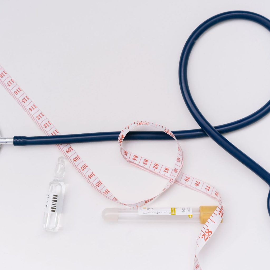 A stethoscope, ampoule, and tape measure on a white background symbolize healthcare essentials. — Using Cinnamomum Extract To