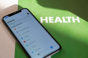Close-up of a smartphone displaying a health app on a green surface with 'HEALTH' text. — Valuable Tips on Choosing the Right