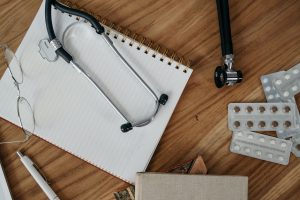Flat lay of medical tools and supplies on a wooden desk surface. — Virtual Varieties: Exploring Delta 10 Gummies Online