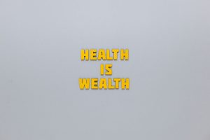 Inspirational phrase 'Health is Wealth' in bold yellow letters on a neutral gray background. — What Are The Most Effective Ph