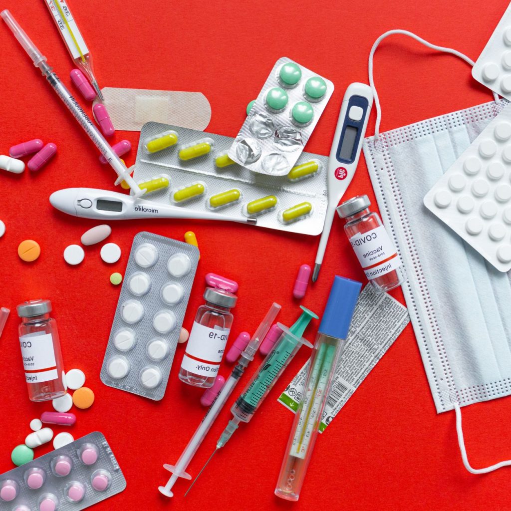 Medical supplies and medications displayed on a red background, emphasizing healthcare essentials. — What To Check While Buyi