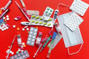 Medical supplies and medications displayed on a red background, emphasizing healthcare essentials. — What To Check While Buyi