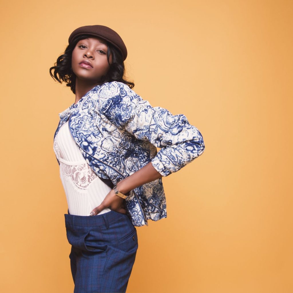 Portrait of a young woman in stylish clothing posing against a yellow background. — What You Need to Know About Retinol