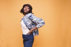 Portrait of a young woman in stylish clothing posing against a yellow background. — What You Need to Know About Retinol